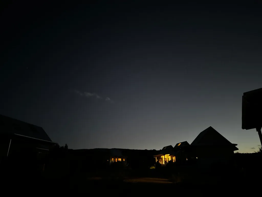 Porchlights illuminate a few cabins against the fading sunset