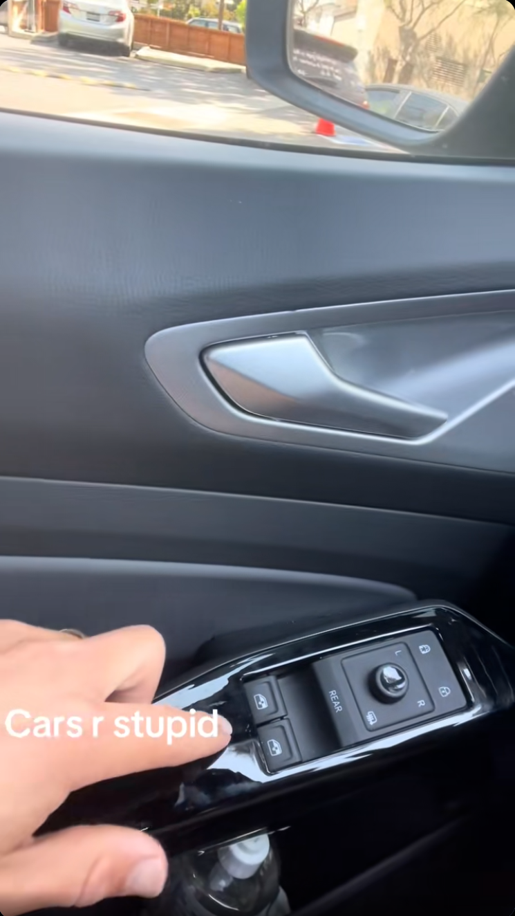 A man in a car, onscreen text 'Cars r stupid'